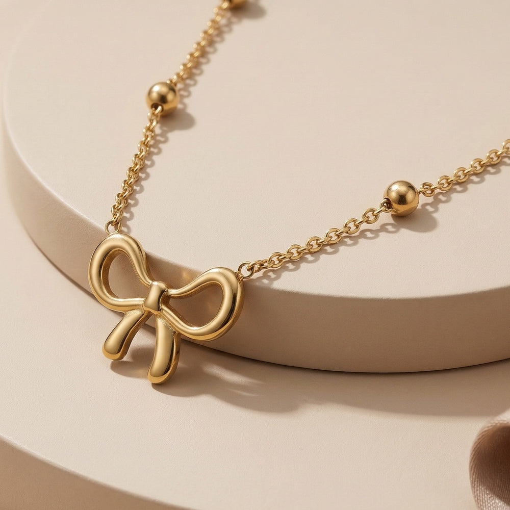 Elegant Gold Ribbon Bow Pendant Necklace with a Bead Chain