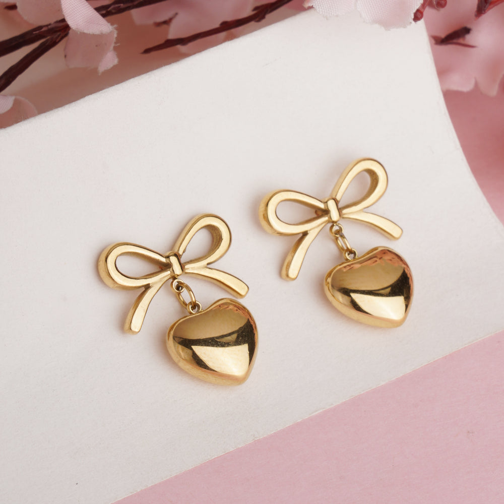 Designer Gold Plated Ribbon Bow Dangle Earrings with Polished Golden Heart Charms