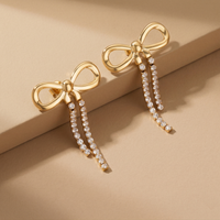 Trendy Gold Plated Ribbon Bow Earrings with Long Crystal Dangles for Party Wear