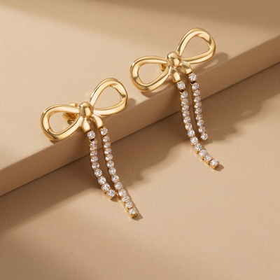 Trendy Gold Plated Ribbon Bow Earrings with Long Crystal Dangles for Party Wear