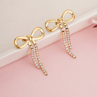 Trendy Gold Plated Ribbon Bow Earrings with Long Crystal Dangles for Party Wear