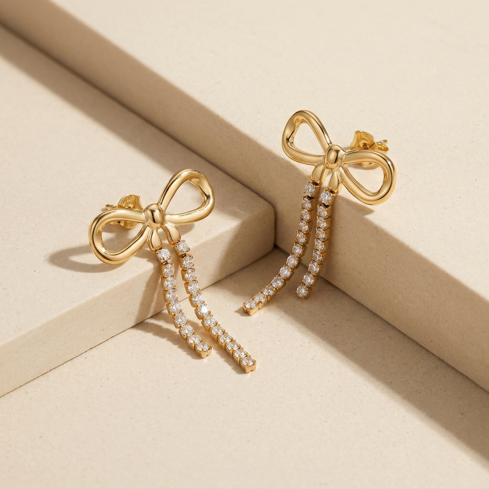 Trendy Gold Plated Ribbon Bow Earrings with Long Crystal Dangles for Party Wear