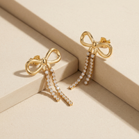 Trendy Gold Plated Ribbon Bow Earrings with Long Crystal Dangles for Party Wear