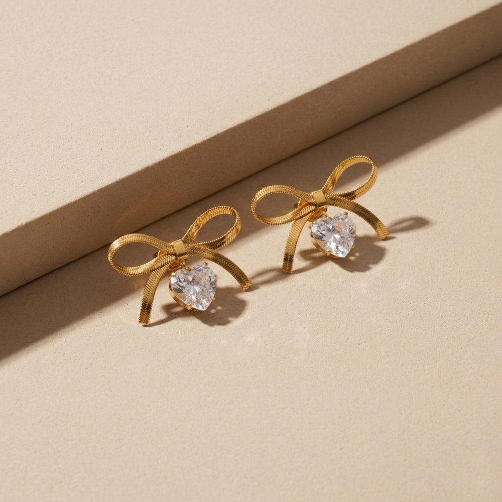 Designer Gold Plated Flat Snake Chain Ribbon Bow Earrings with Sparkling Heart-Cut Crystal