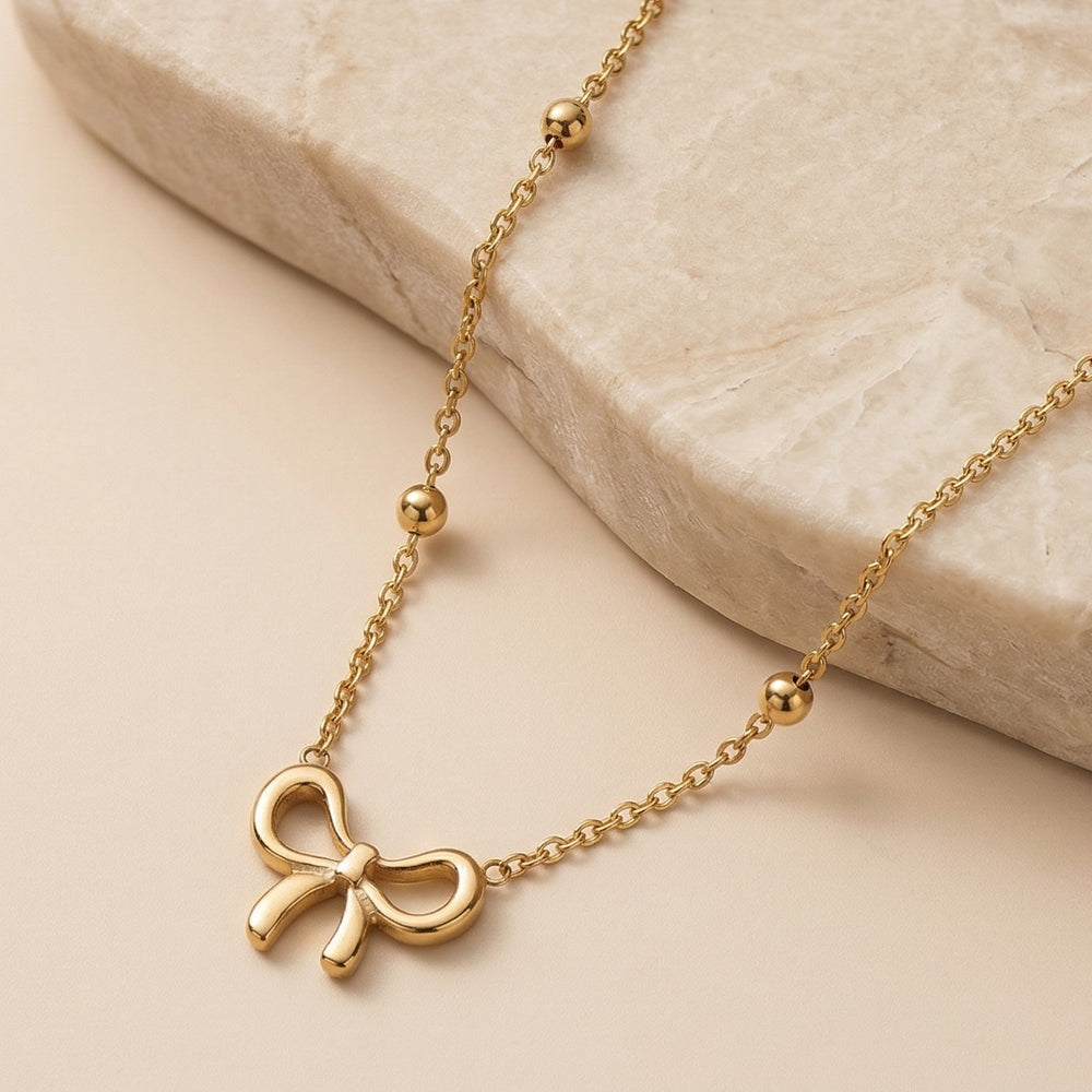 Elegant Gold Ribbon Bow Pendant Necklace with a Bead Chain