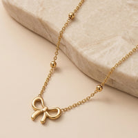 Elegant Gold Ribbon Bow Pendant Necklace with a Bead Chain