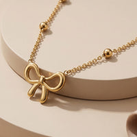 Elegant Gold Ribbon Bow Pendant Necklace with a Bead Chain